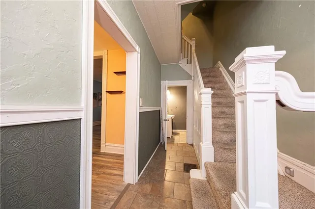 a view of a bathroom with mirror and shower