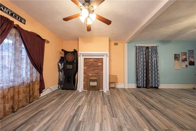 wooden floor in an empty room with a fireplace