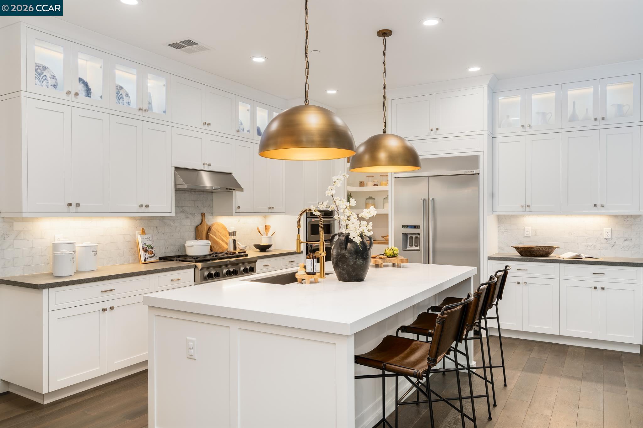 1150 Trumpet Vine Lane San Ramon, CA 94582 - Photo 11 of 45 a kitchen with stainless steel appliances a sink a stove a dining table and chairs