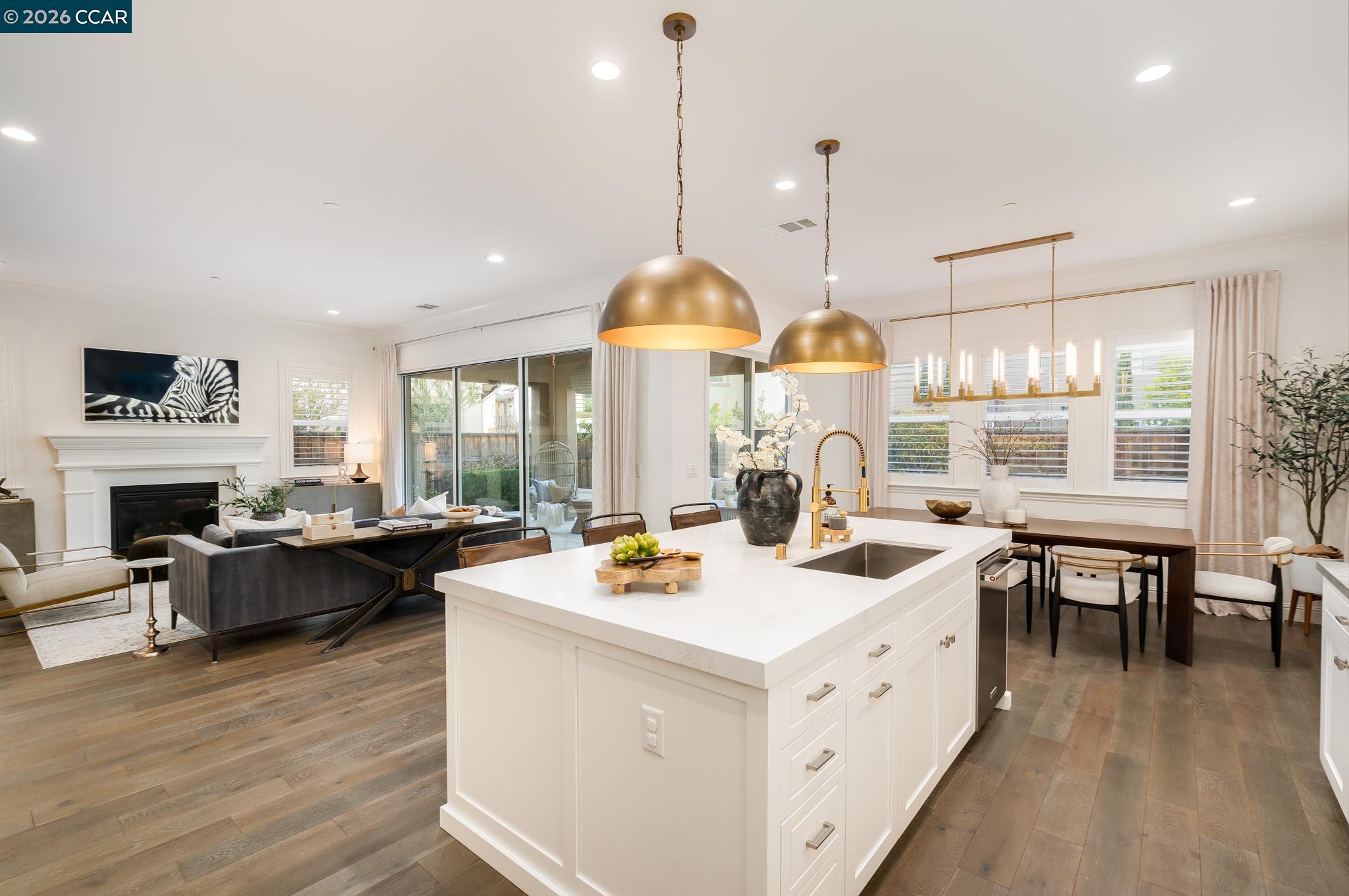 1150 Trumpet Vine Lane San Ramon, CA 94582 - Photo 14 of 45 a kitchen with a stove a counter space dining table and chairs