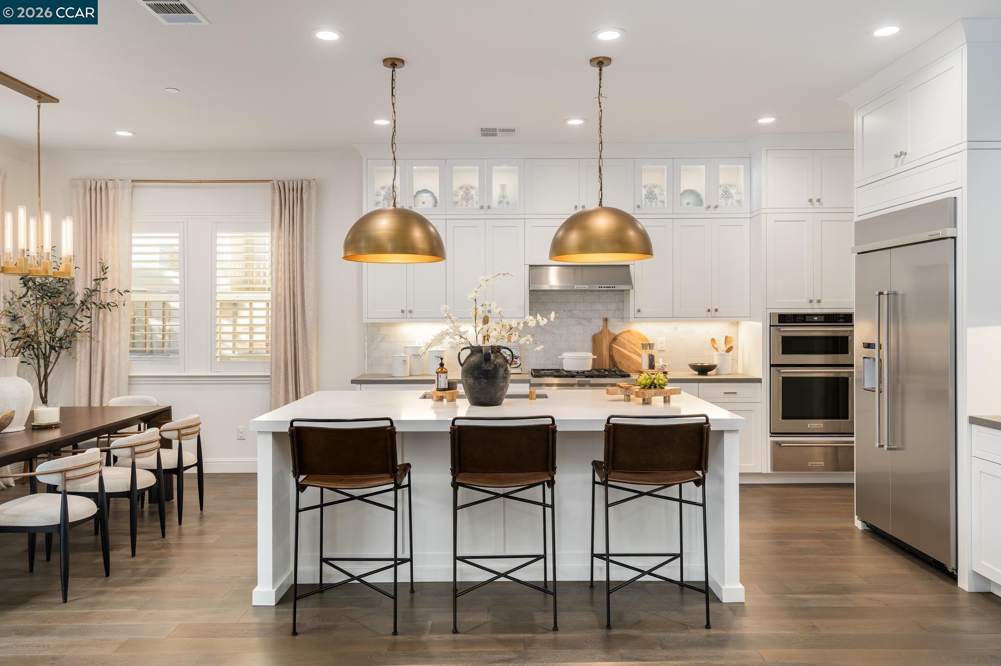 1150 Trumpet Vine Lane San Ramon, CA 94582 - Photo 9 of 45 a kitchen with stainless steel appliances granite countertop a stove a refrigerator a kitchen island a dining table and chairs
