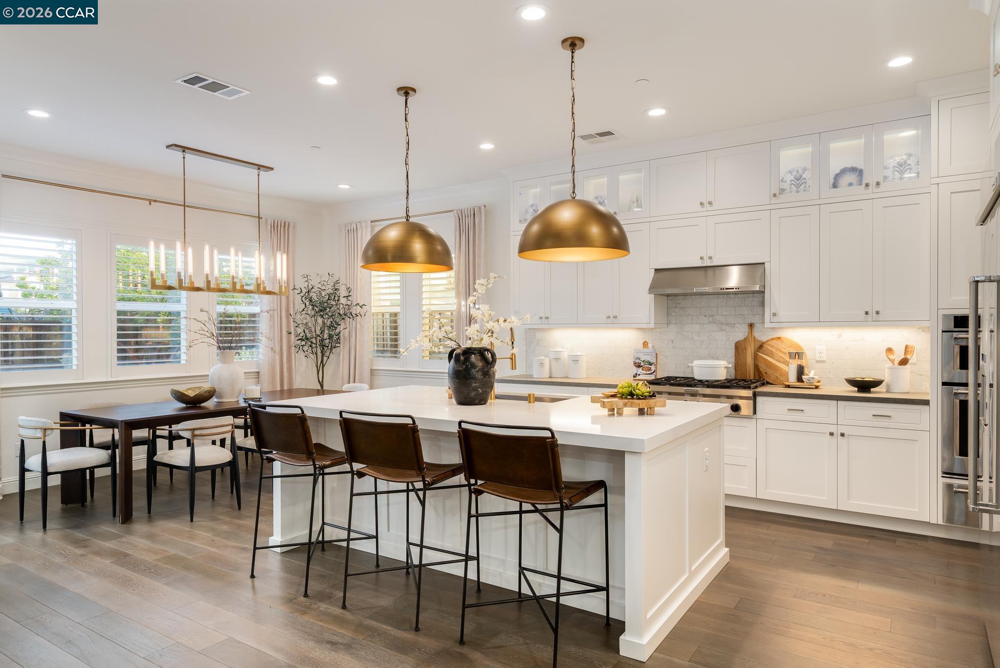 1150 Trumpet Vine Lane San Ramon, CA 94582 - Photo 10 of 45 a kitchen with lots of counter space dining table and chairs