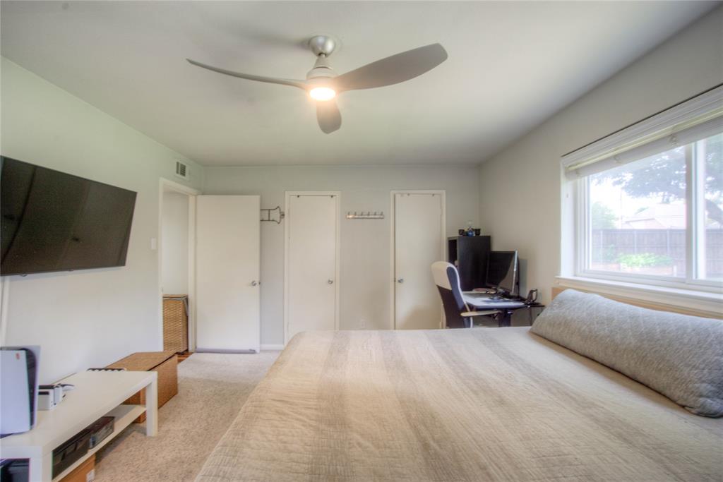 12231 Veronica Road Farmers Branch, TX 75234 - Photo 14 of 26 Carpeted bedroom featuring a ceiling fan with integrated lighting, a large window with blinds, and white doors