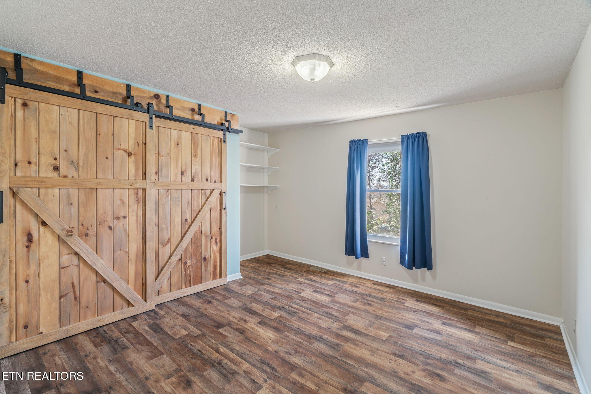 744 Butler Drive Loudon, TN 37774 - Photo 35 of 59 a view of an empty room with wooden floor