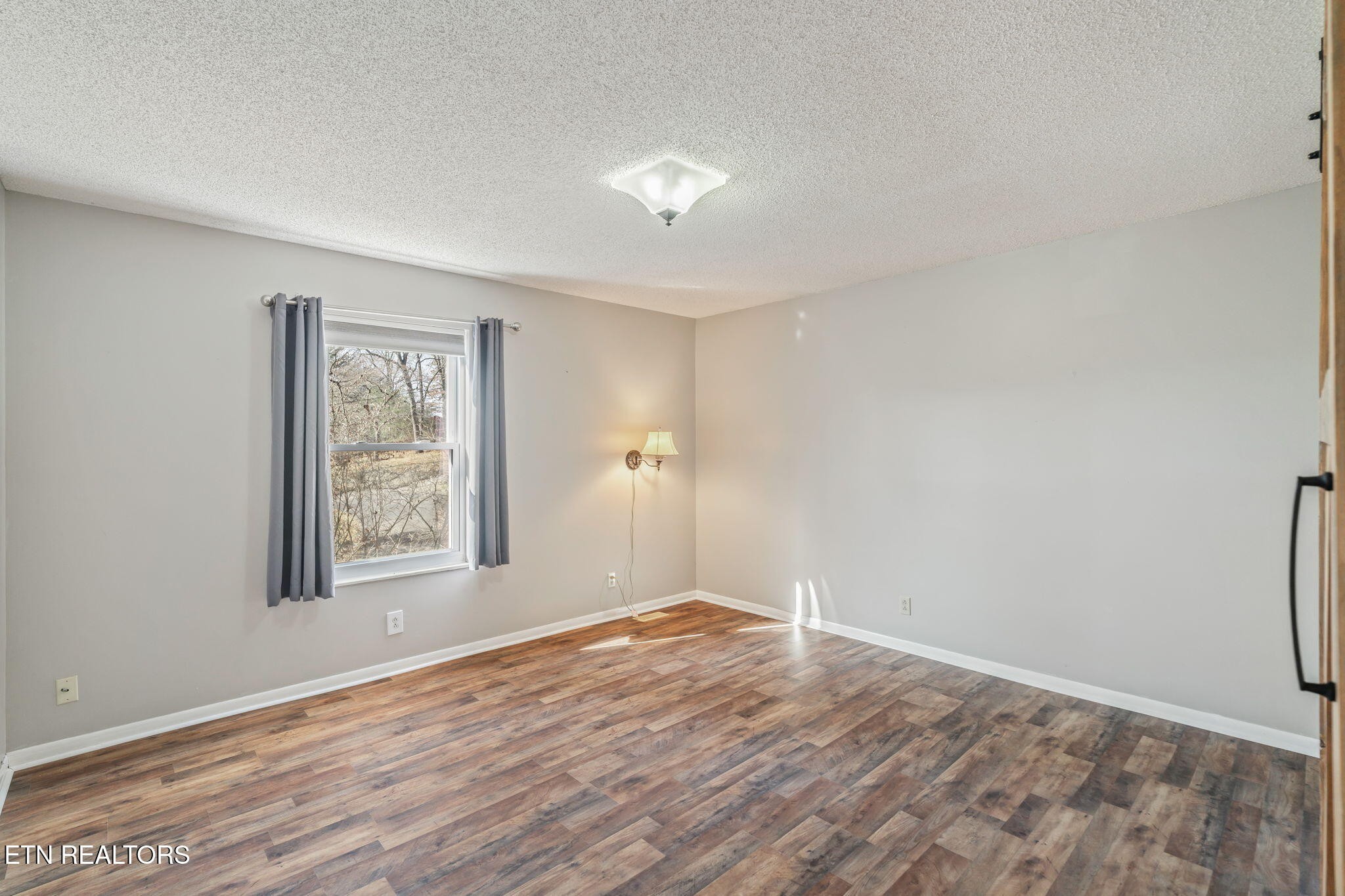 744 Butler Drive Loudon, TN 37774 - Photo 36 of 59 a view of empty room with wooden floor and fan
