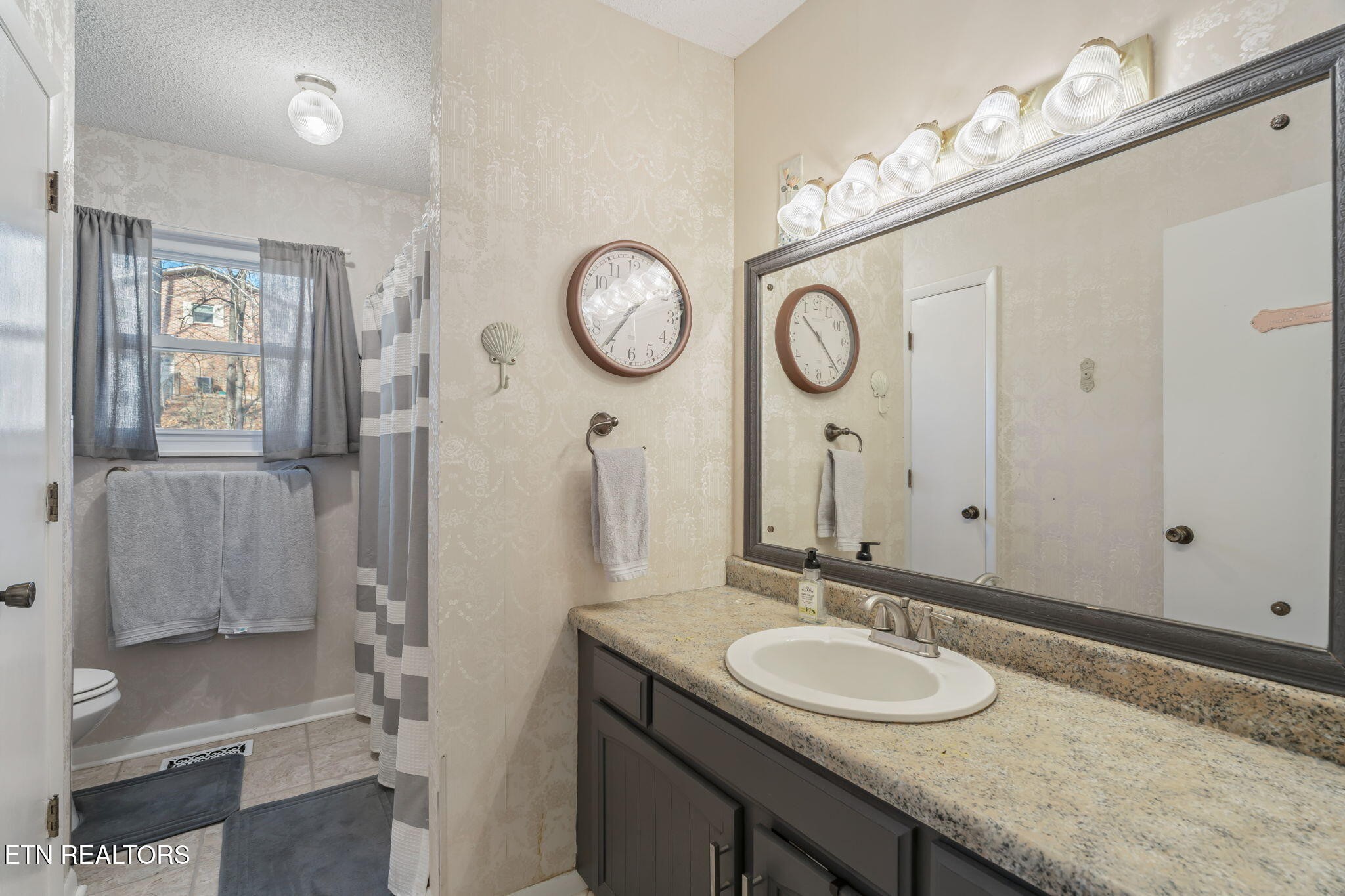 744 Butler Drive Loudon, TN 37774 - Photo 38 of 59 a bathroom with a granite countertop sink and a mirror