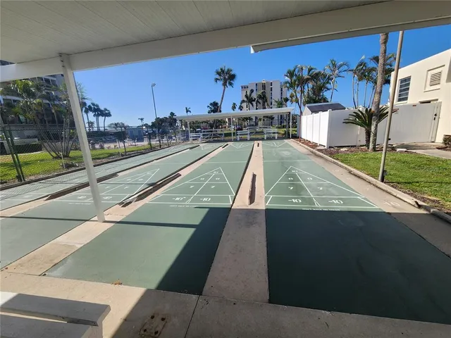 an aerial view of a swimming pool with outdoor seating and yard