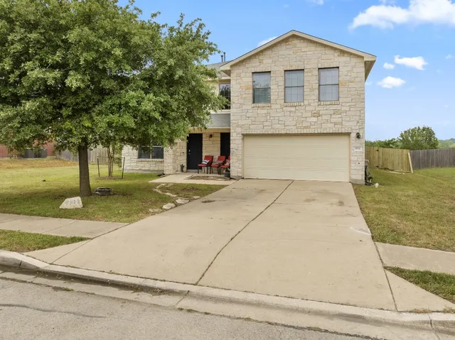 a front view of a house with a yard and garage