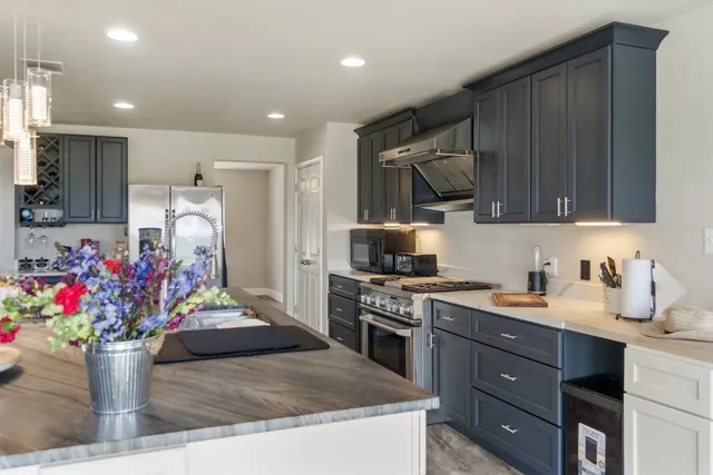 a kitchen with a sink cabinets and microwave