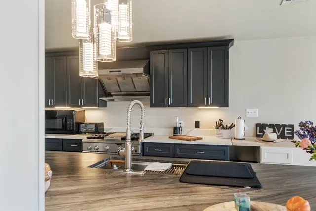 a kitchen with a sink cabinets and window