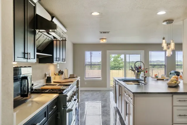 a kitchen with a sink stove and cabinets