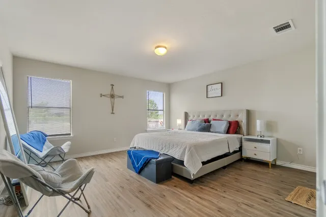 a bedroom with a bed and window