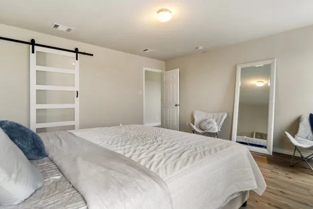 a bedroom with a bed and a view of closet