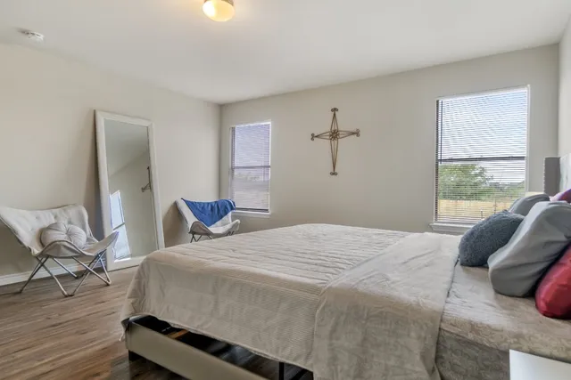 a bedroom with a bed and wooden floor