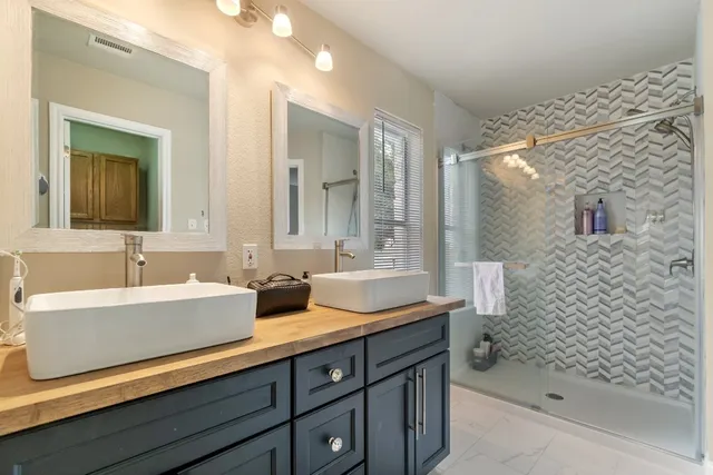 a bathroom with a sink a mirror and a bathtub
