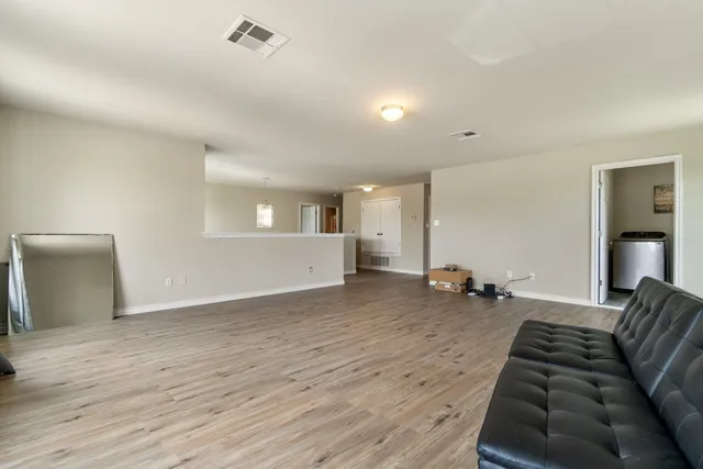 a view of a livingroom with furniture and wooden floor