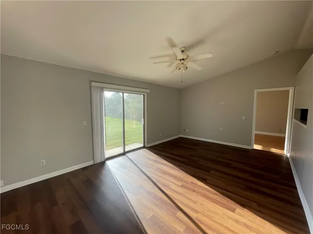 a view of an empty room and wooden floor
