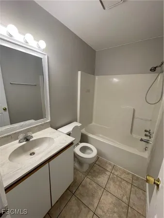 a bathroom with a sink double vanity mirror and a bathtub