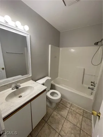 a bathroom with a sink double vanity mirror and a bathtub