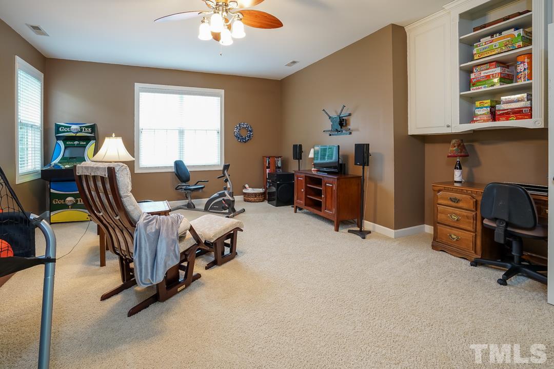 2920 Elmfield Street Raleigh, NC 27614 - Photo 22 of 30 The bonus room features a double door entry, two double windows and a ceiling fan. Built in cabinets and open shelving are great for storage.