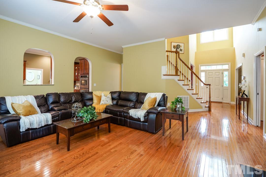 2920 Elmfield Street Raleigh, NC 27614 - Photo 6 of 30 The gleaming hardwood floors continue into the large family room. This view looks back towards the two-story foyer and front door.