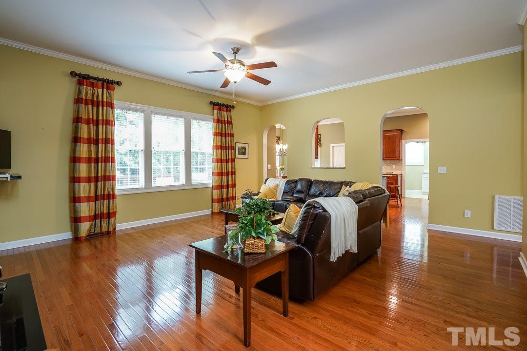 2920 Elmfield Street Raleigh, NC 27614 - Photo 8 of 30 A triple window fills the room with light. Two arched doorways and an arched opening provide a view into the kitchen. A ceiling fan tops the family room.