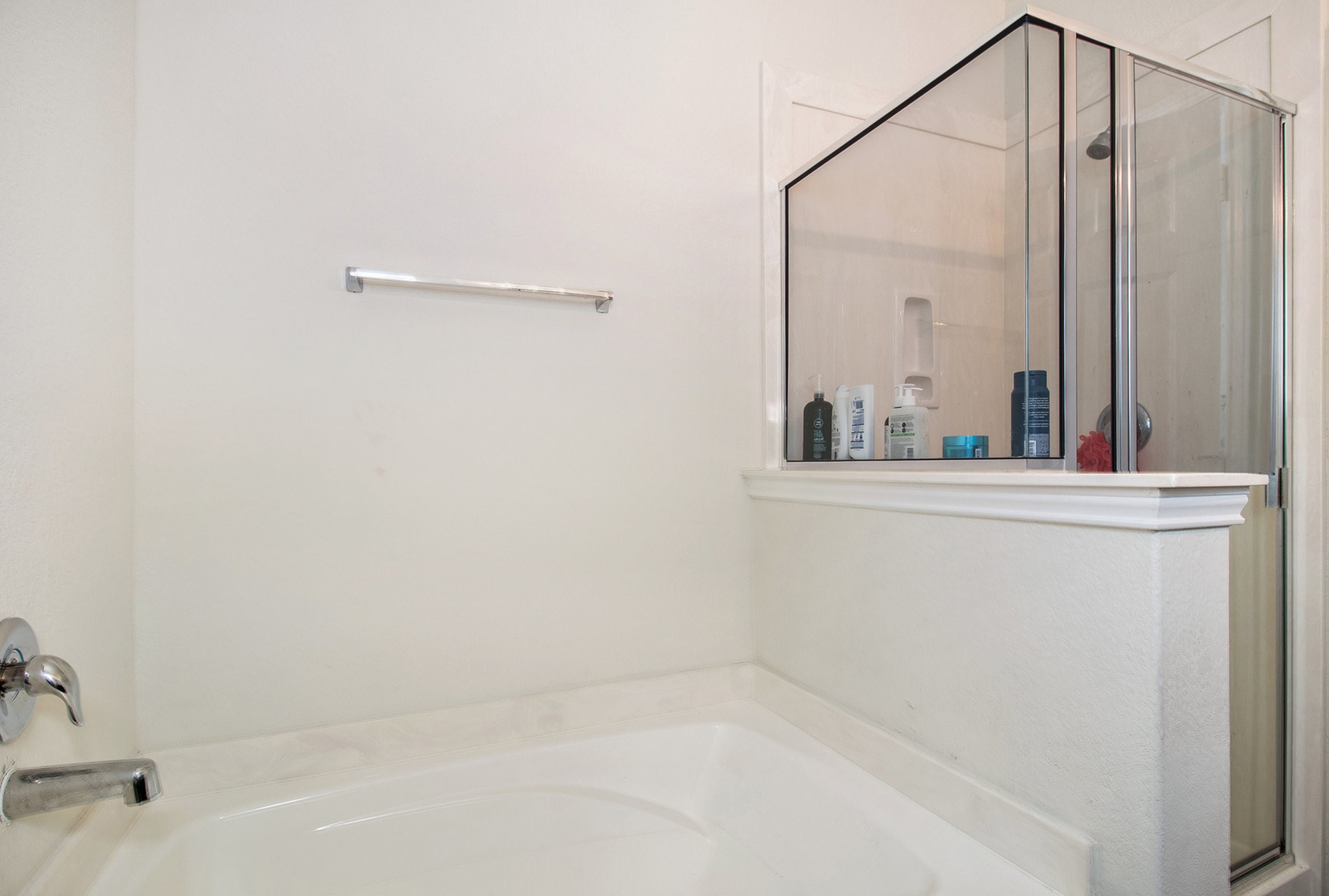 5726 Pampus Prairie Road Katy, TX 77493 - Photo 16 of 28 a bathroom with a bathtub and a shower