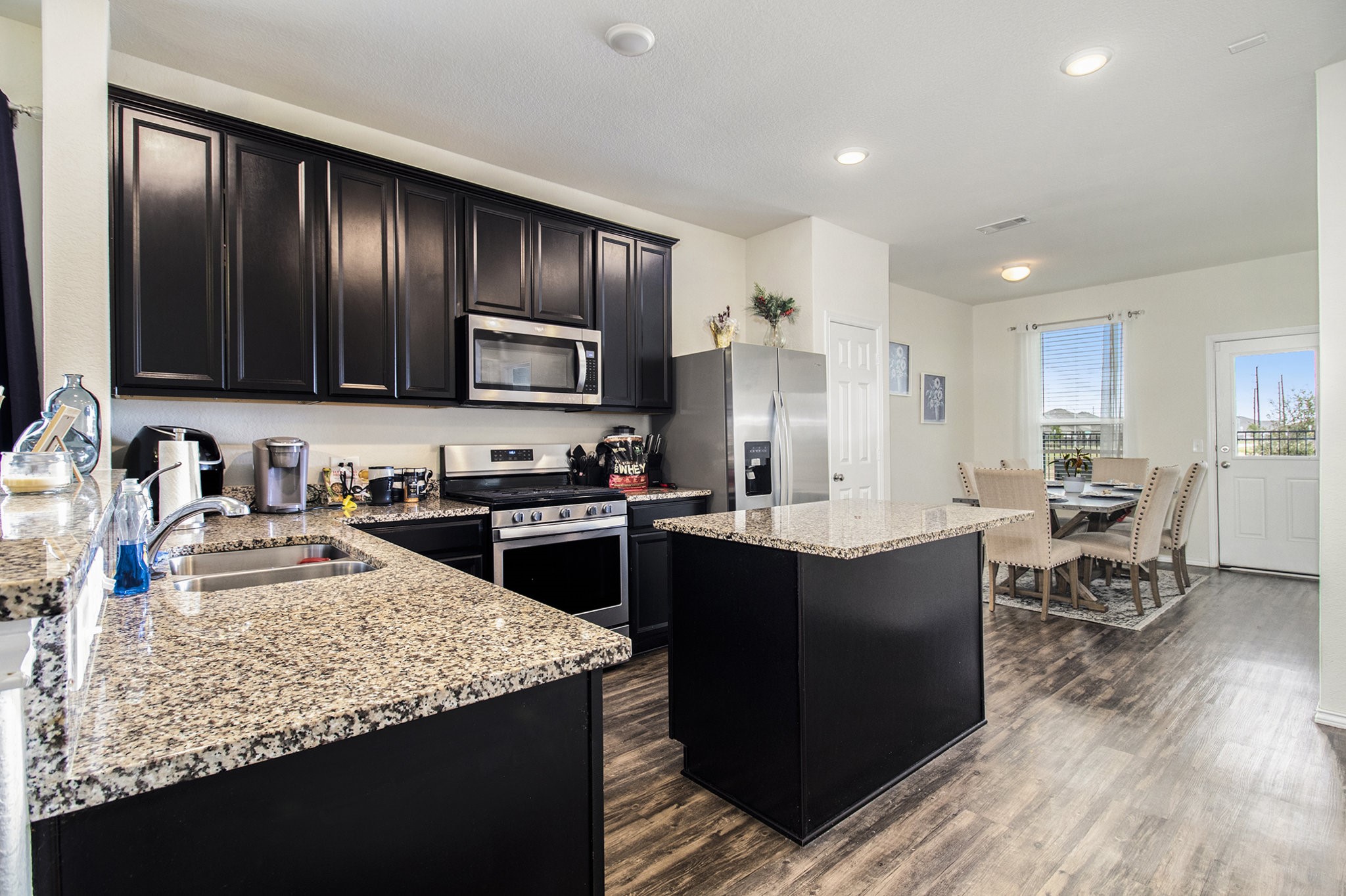 5726 Pampus Prairie Road Katy, TX 77493 - Photo 9 of 28 a kitchen with granite countertop stainless steel appliances and wooden cabinets