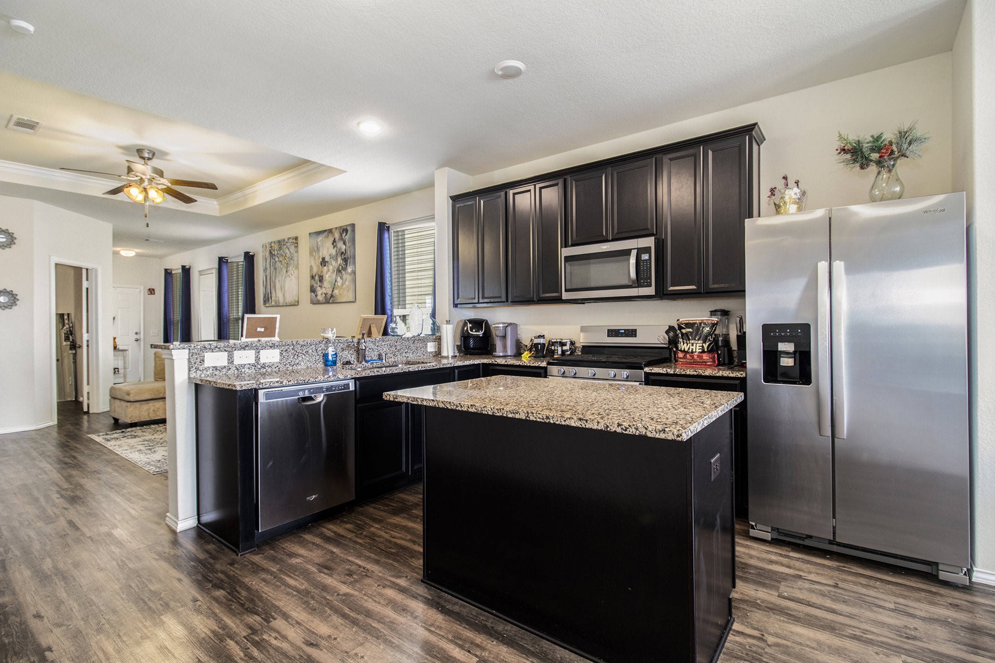 5726 Pampus Prairie Road Katy, TX 77493 - Photo 10 of 28 a kitchen with stainless steel appliances granite countertop a stove a refrigerator and a sink