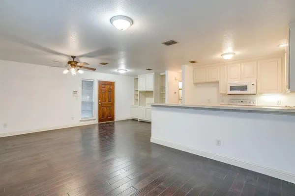 a view of kitchen with refrigerator microwave and stove