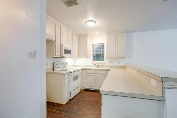 a kitchen that has a sink and a stove in it