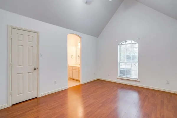 a view of a livingroom with a fireplace a chandelier and windows
