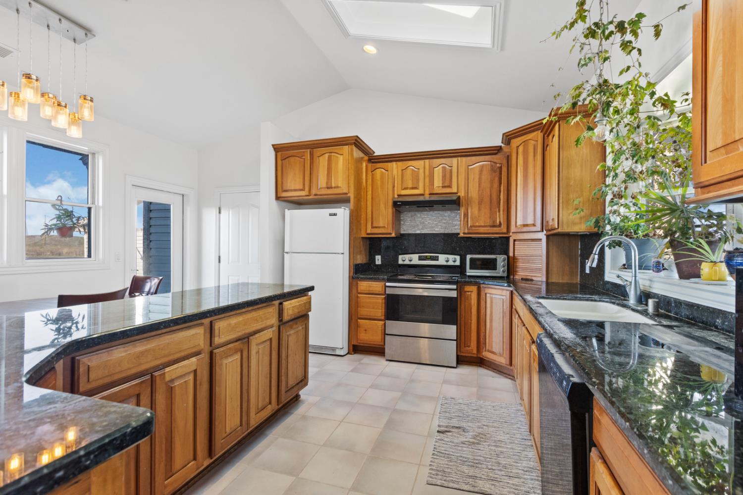 44643 County Road 29 Davis, CA 95618 - Photo 15 of 41 a kitchen with stainless steel appliances granite countertop a stove a sink and a refrigerator