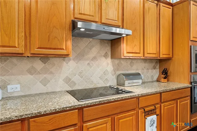 a kitchen with granite countertop cabinets and sink