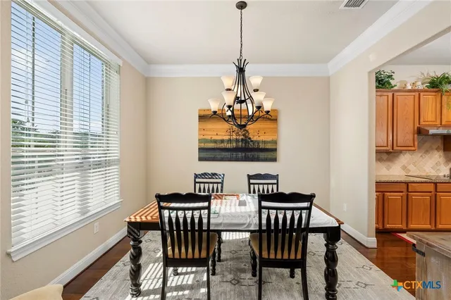 a view of a dining room with furniture window and outside view