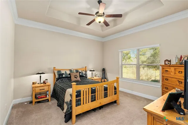 a bedroom with a bed next to a window