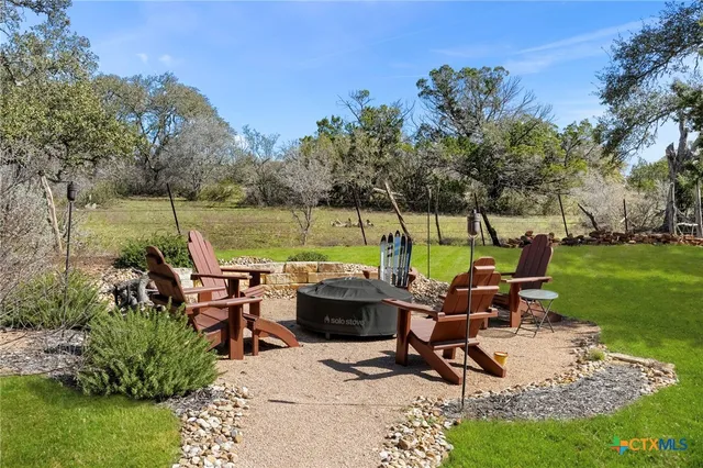 a view of a lake with furniture and garden