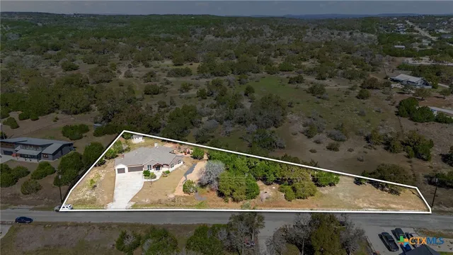 an aerial view of a house with a yard