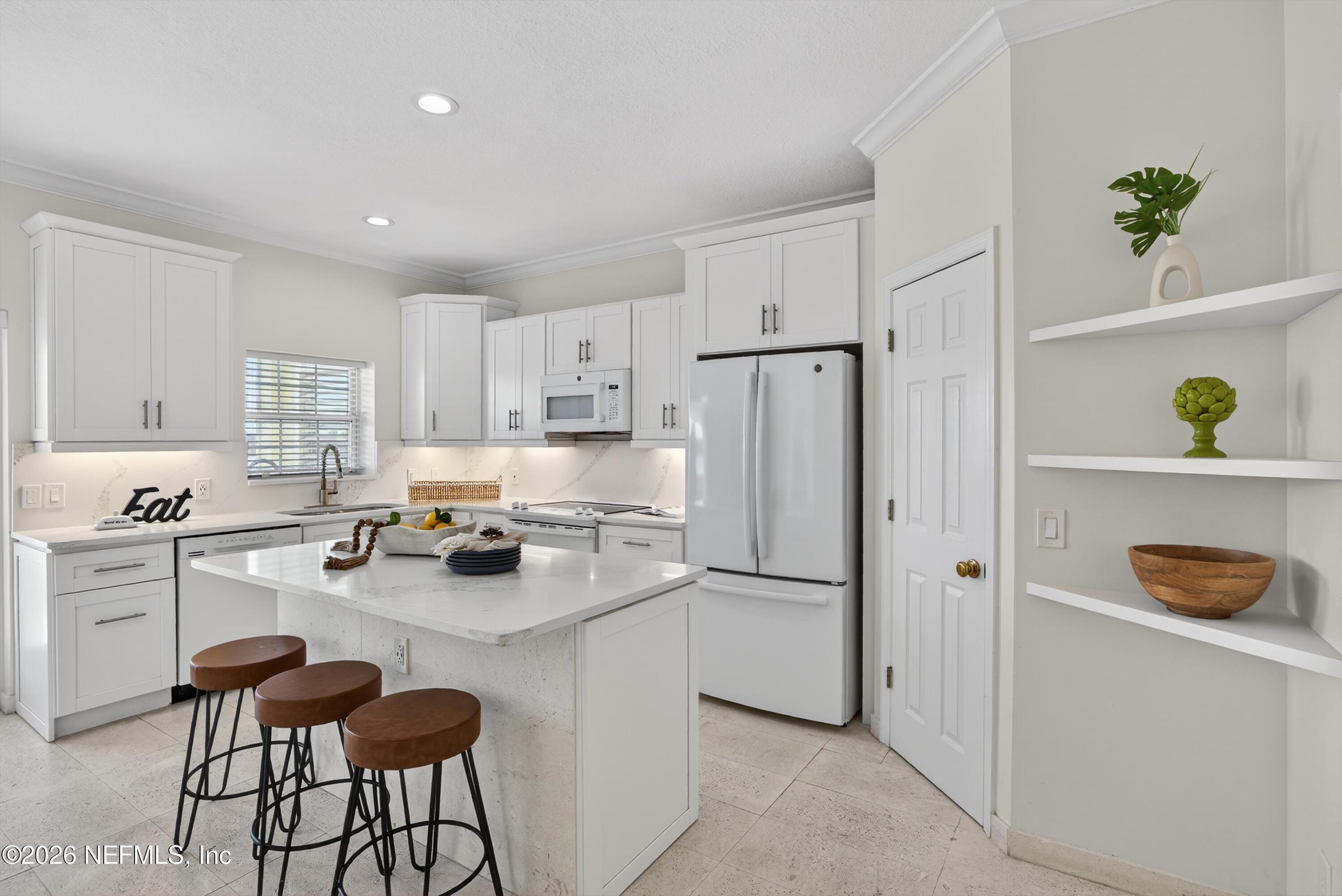 9179 June Lane St. Augustine, FL 32080 - Photo 11 of 56 a kitchen with a refrigerator and a sink