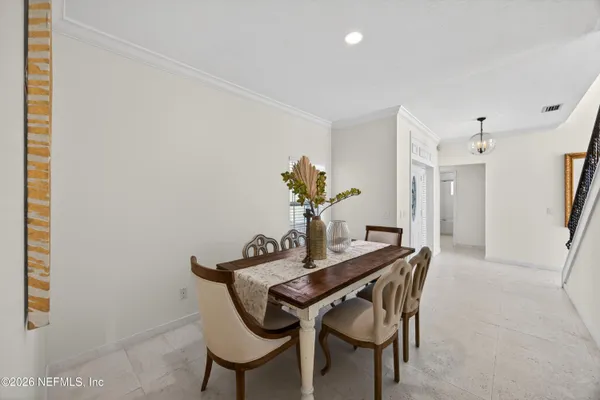 a view of a dining room with furniture and window