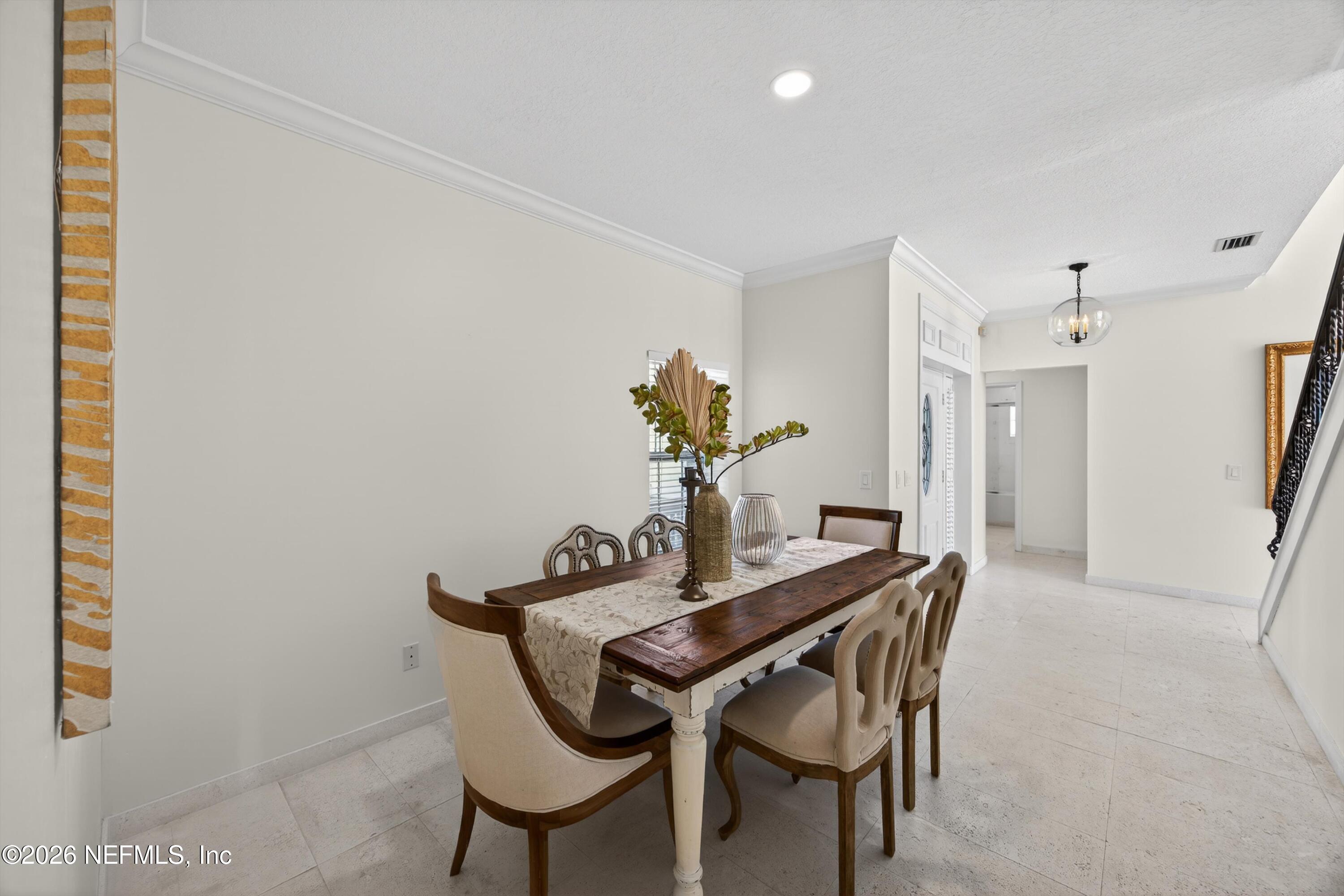 9179 June Lane St. Augustine, FL 32080 - Photo 13 of 56 a dining room with furniture and wooden floor