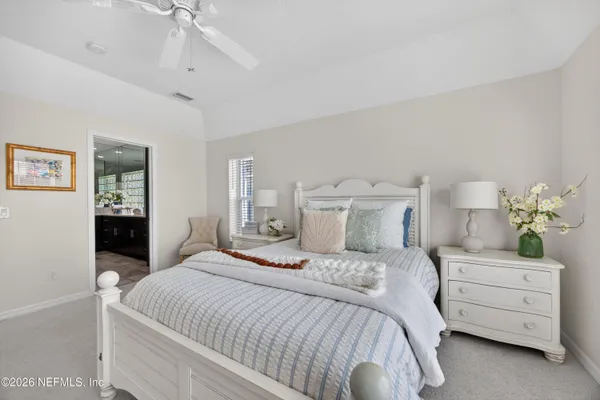 a bed room with a bed and a chair