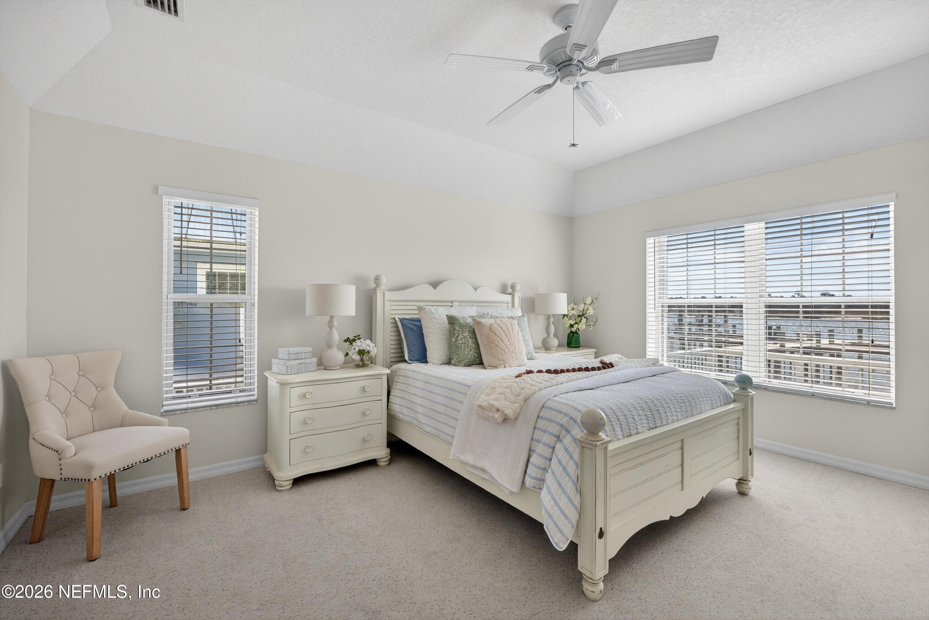 9179 June Lane St. Augustine, FL 32080 - Photo 16 of 56 a bed room with a bed and a chair