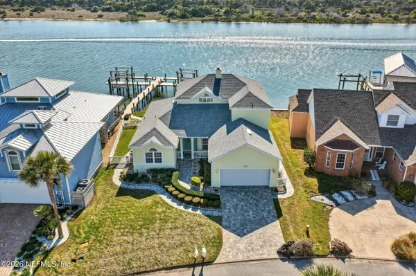 an aerial view of a house with a yard