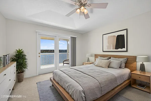 a bedroom with a large bed and a flat screen tv