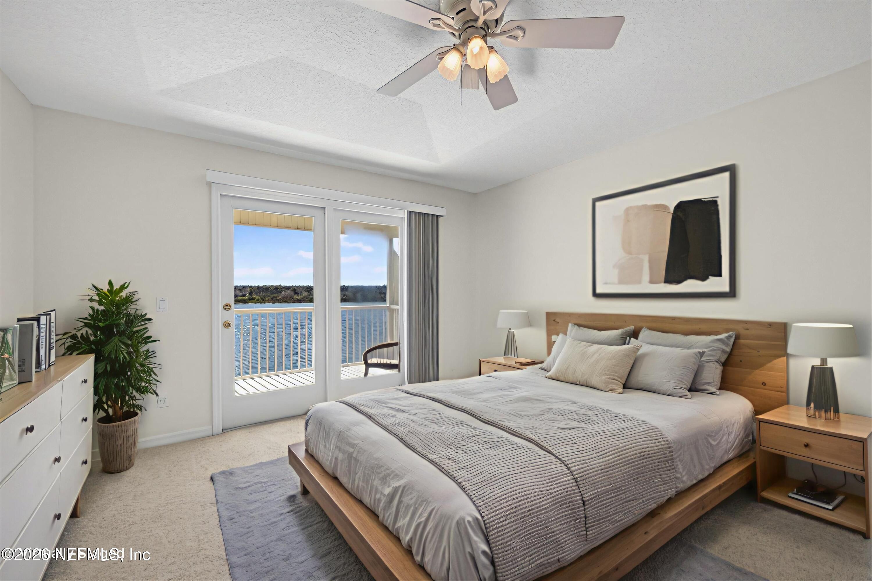 9179 June Lane St. Augustine, FL 32080 - Photo 23 of 56 a bedroom with a large bed and a window