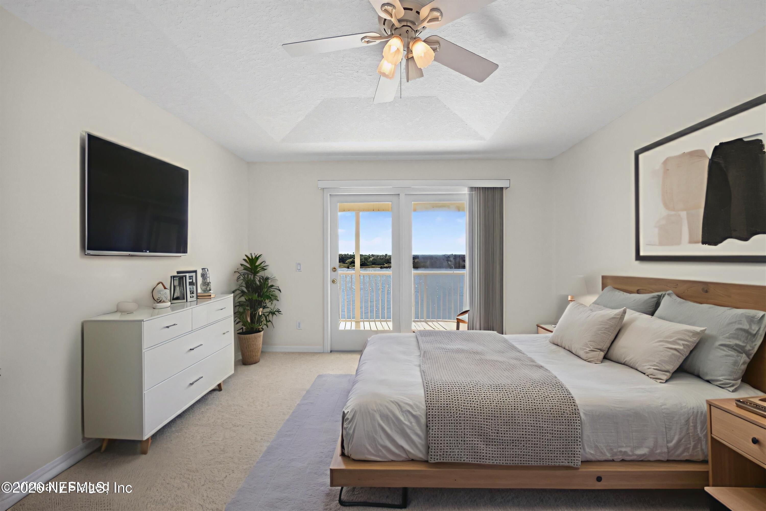 9179 June Lane St. Augustine, FL 32080 - Photo 24 of 56 a bedroom with a large bed and a flat screen tv