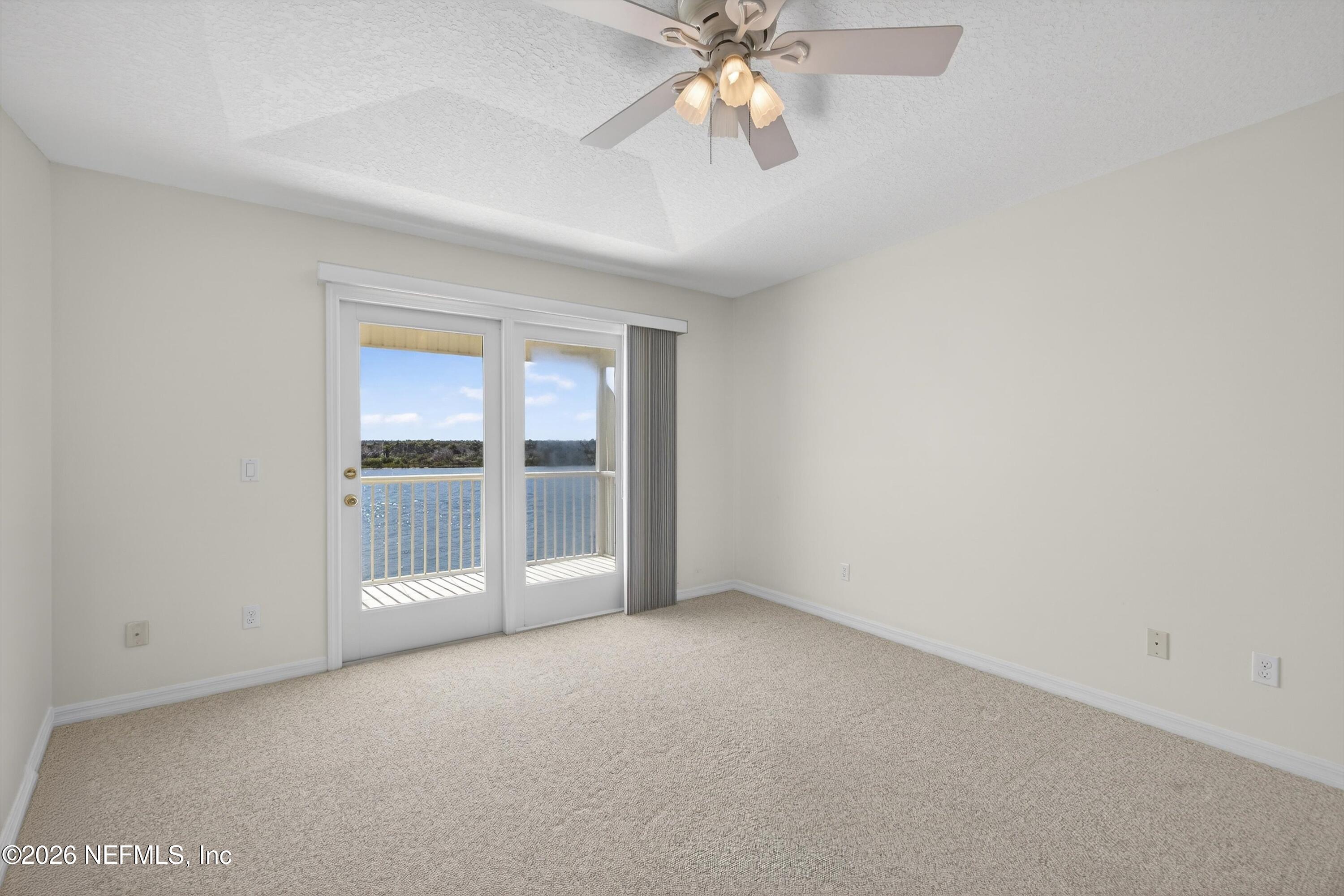9179 June Lane St. Augustine, FL 32080 - Photo 26 of 56 an empty room with chandelier fan