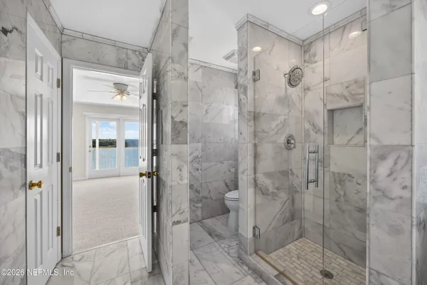 a view of staircase with wooden floor and a rug