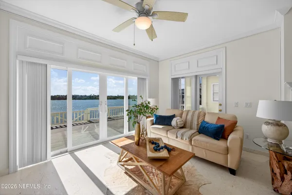 a living room with furniture and a chandelier